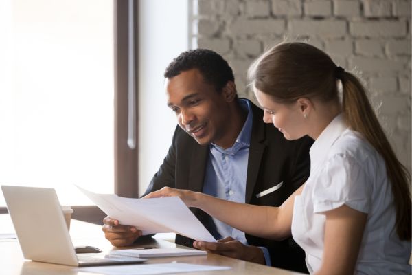 Female financial advisor insurer consulting male african-american client about contract Female financial advisor insurer consulting male african-american client about contract