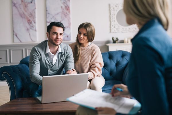 Happy couple planning their future while consulting with insurance agent Happy couple planning their future while consulting with insurance agent