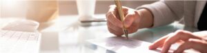 woman writing on paper