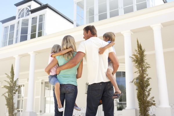 Young Family Standing outside Dream Home Young Family Standing outside Dream Home